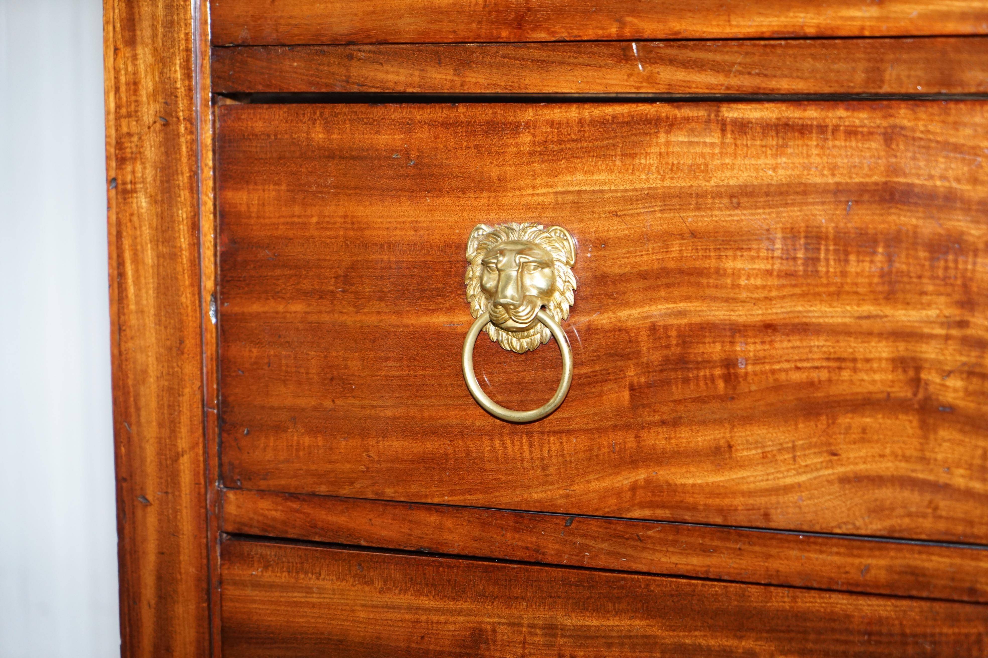 19th-century Empire commode with a marble top and lion paw feet.