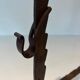Pair of wrought iron andirons with adjustable supports and tripod feet.