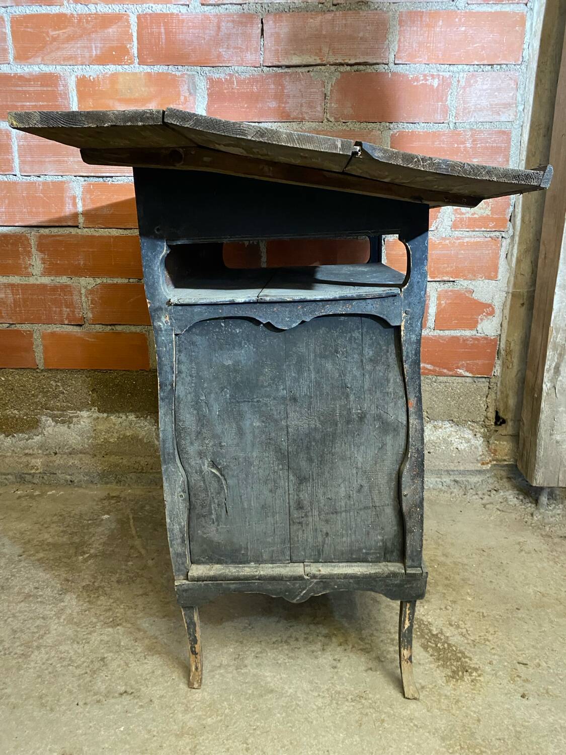 Antique writing desk, blackened wooden filing cabinet.