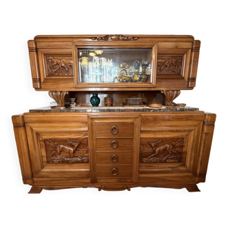 Solid wood sideboard with marble top and carved panels.