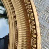 Antique oval mirror in gilded stucco with gold leaf, 19th century