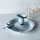 Old candle holder in white enameled metal