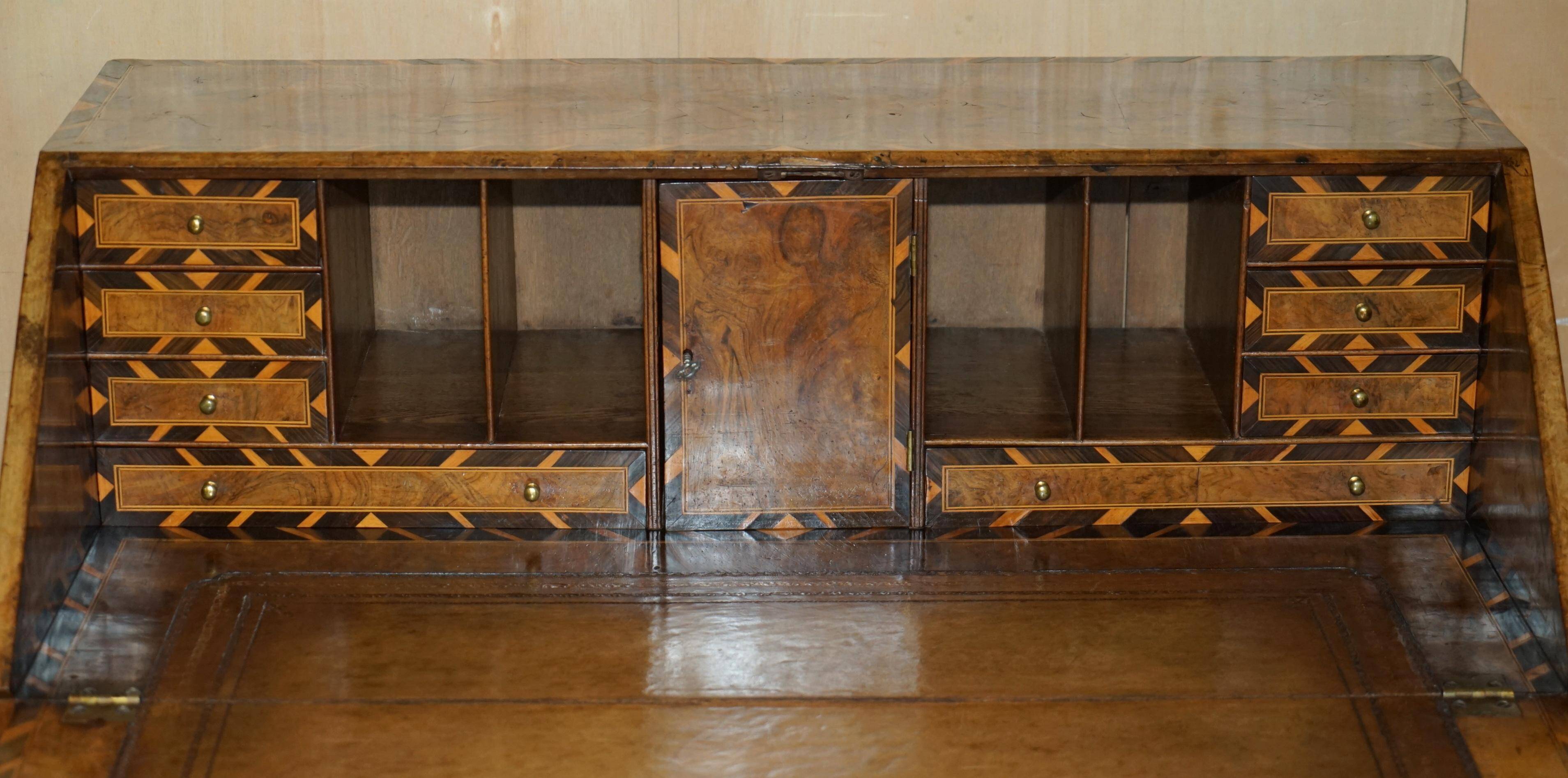 Antique George II bureau from 1740 in walnut, rosewood, and leather.