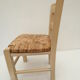 Children's chair of greige color in wood and straw
