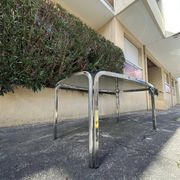 Vintage curved rectangular dining table in smoked glass and metal.