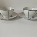 Two Art Deco porcelain cups and saucers with silver trim.