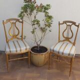Pair of chairs with a golden lyre