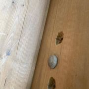 Victorian commode from the 19th century stripped to raw solid wood with ceramic knobs.