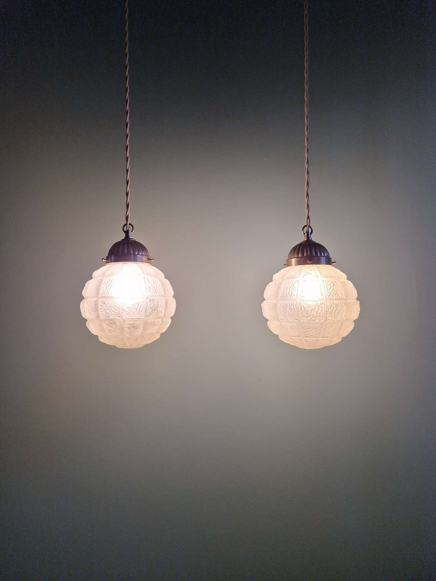 Art Deco trio of frosted glass pendants, 1920s-30s.