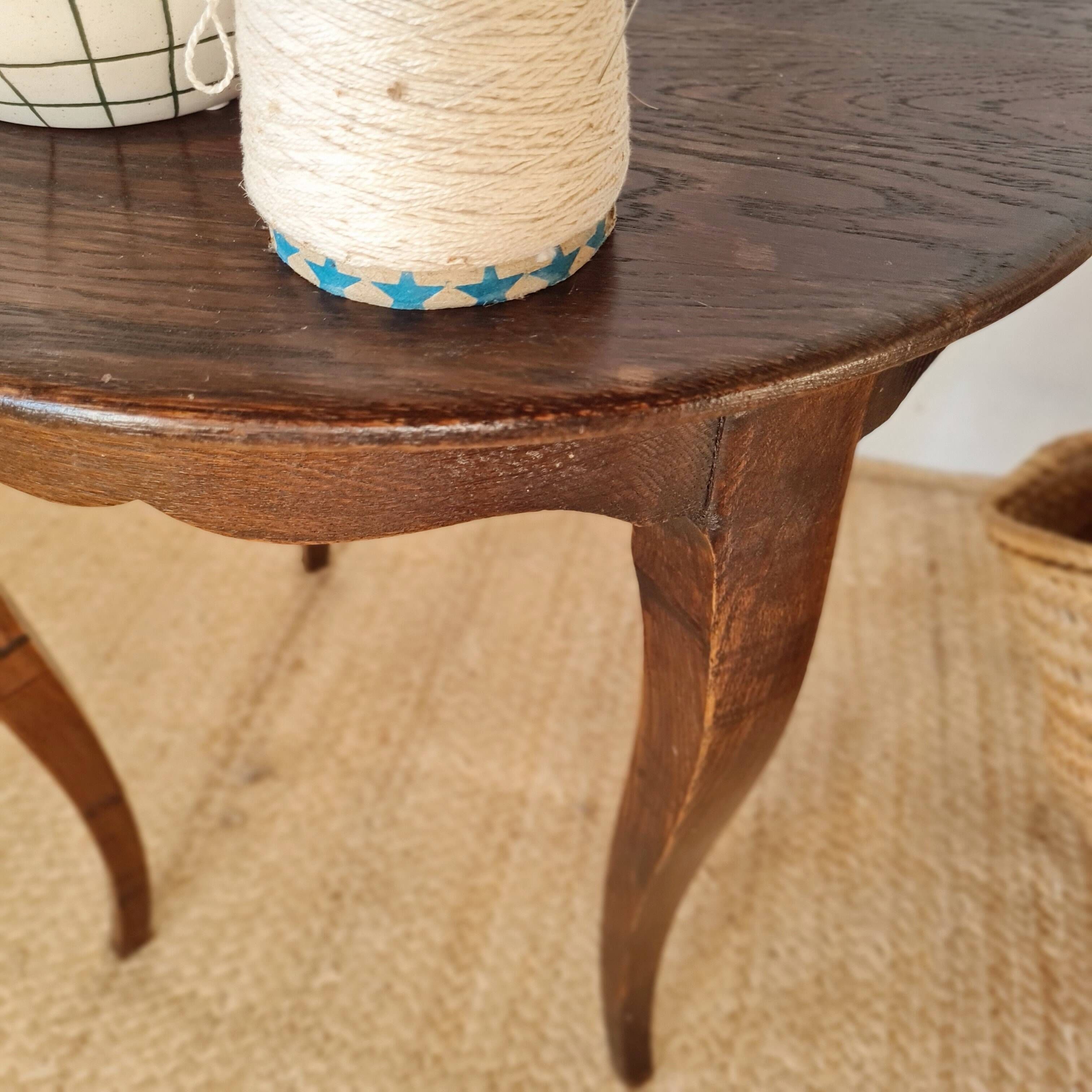 Vintage solid wood side table with curved legs.
