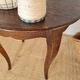 Vintage solid wood side table with curved legs.