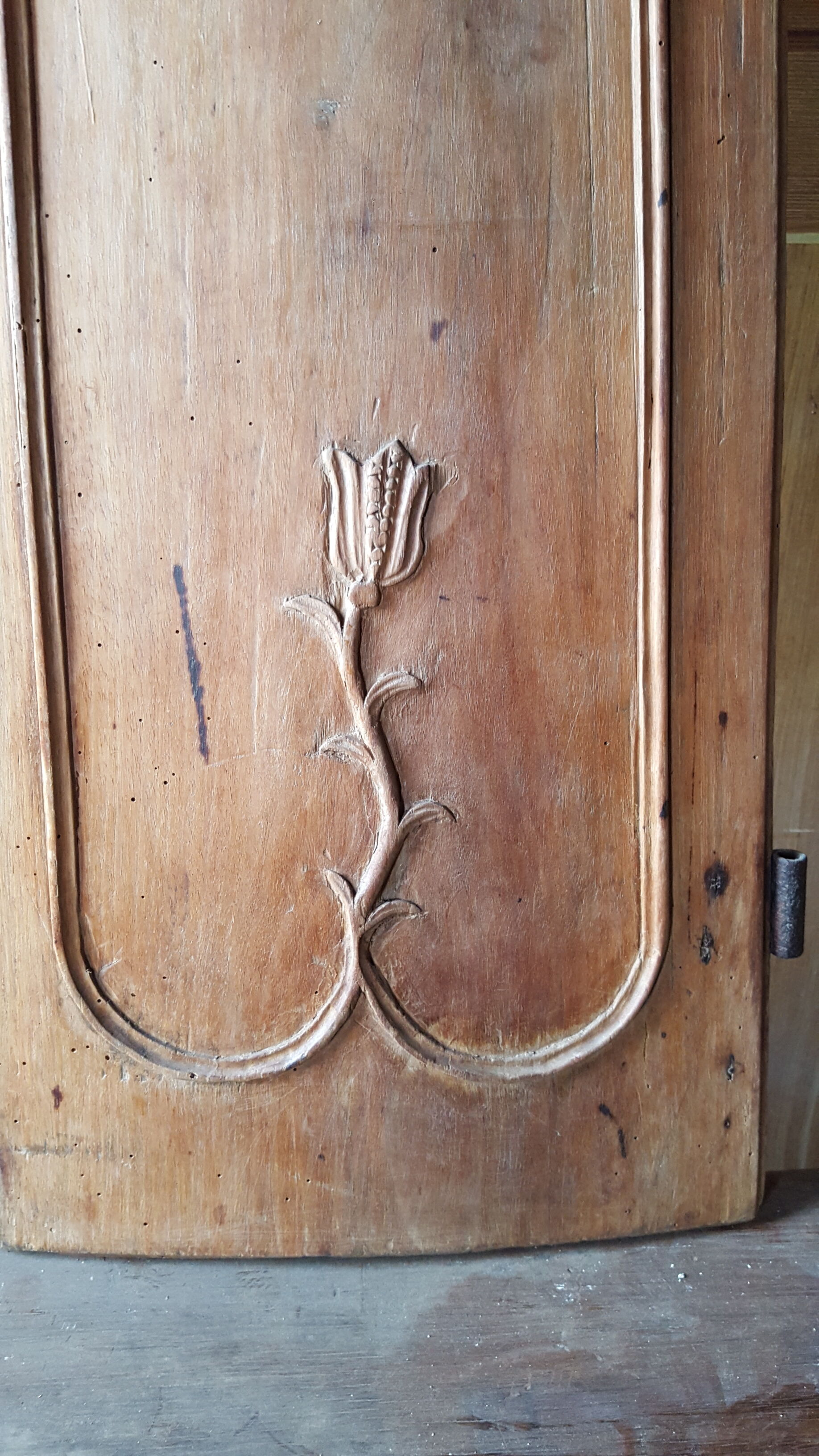 Wearing old 18th century decoration carved with flowers and foliage