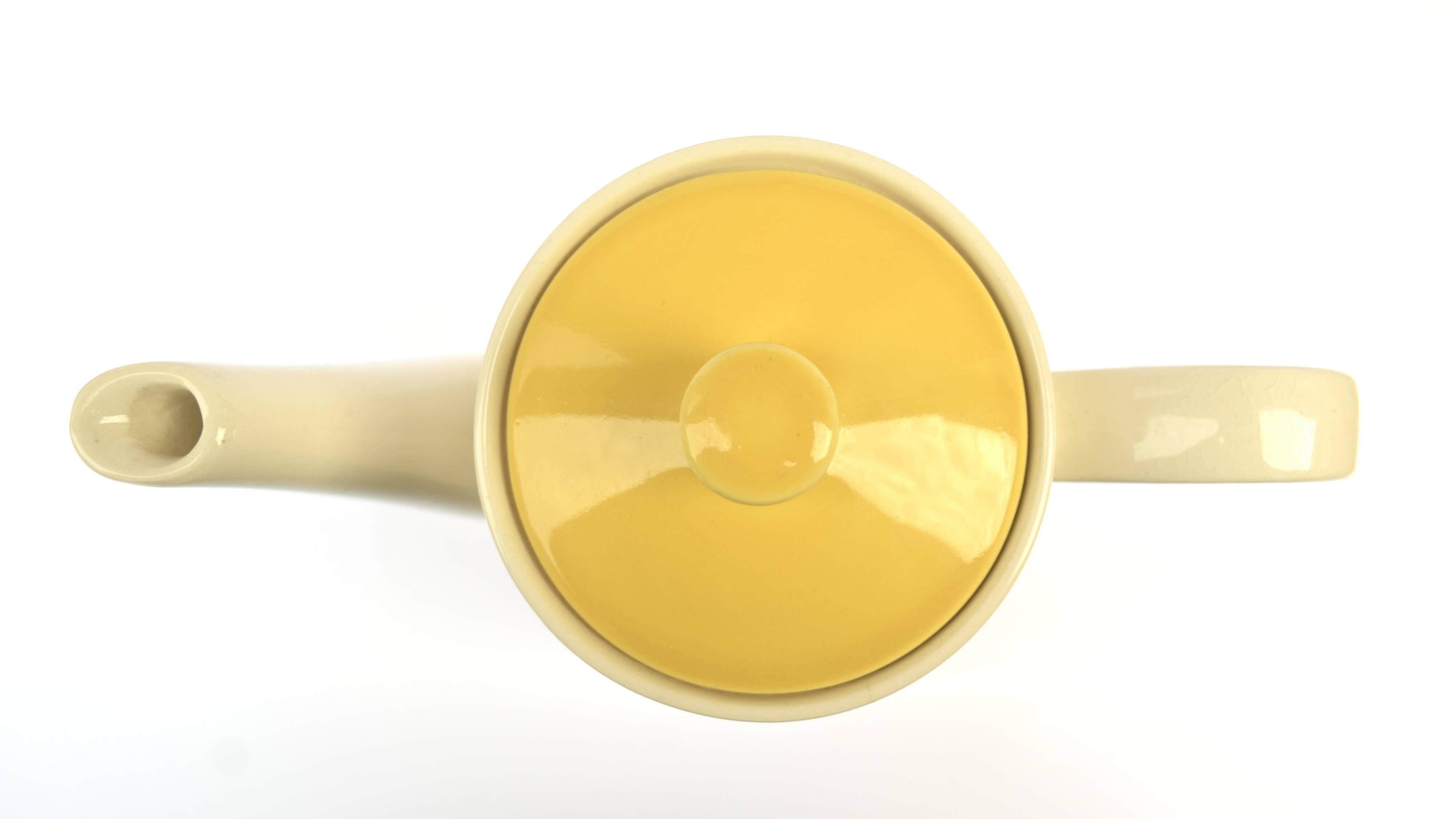 Old glazed ceramic coffee pot decorated with sunflowers