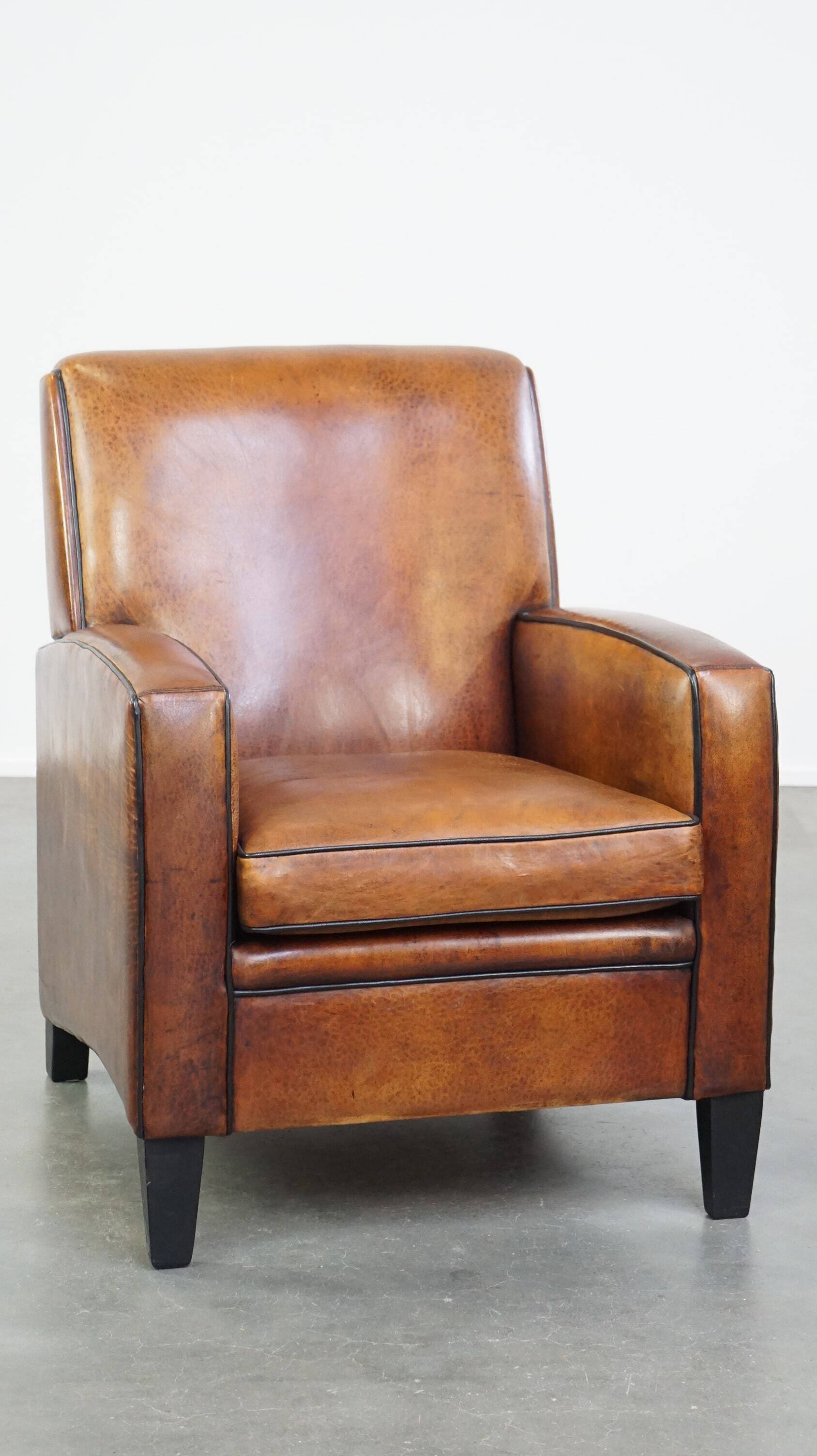 Art Deco design sheepskin leather armchair with a stunning patina