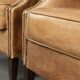 Set of two light cowhide wingback armchairs with a timeless English look