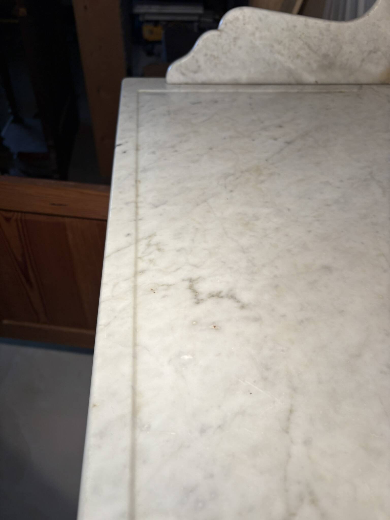 Antique wood and marble kitchen sideboard with carved backsplash