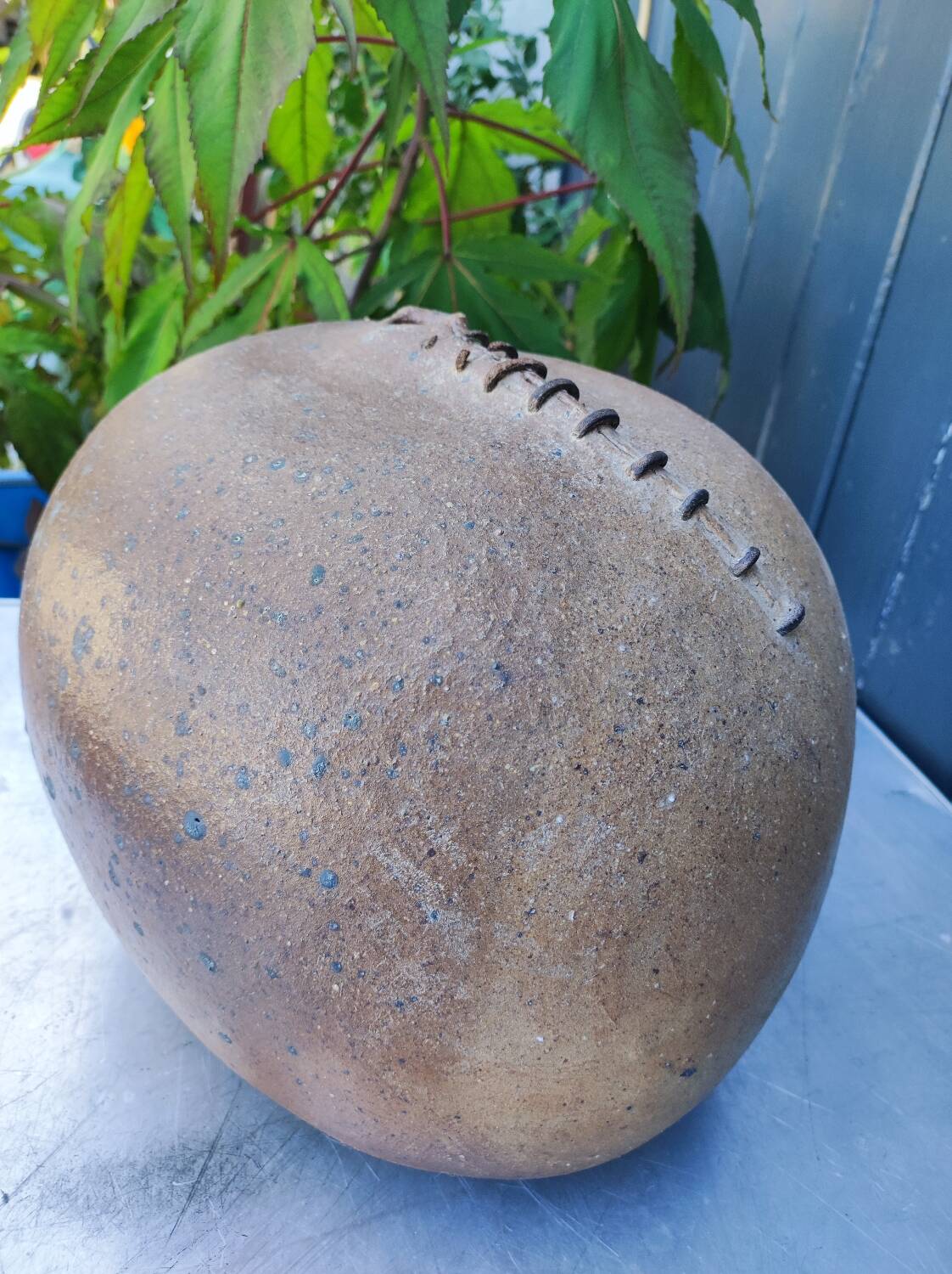 Vintage sandstone vase, in the shape of a rugby ball, signed