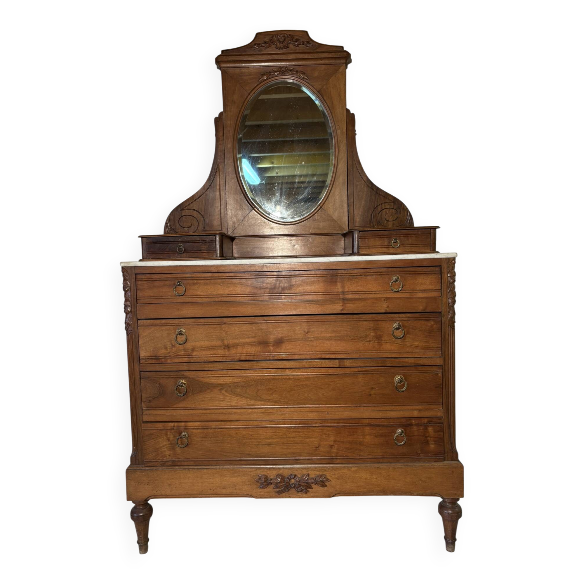 Antique carved wooden dressing table with marble and tilting oval mirror.