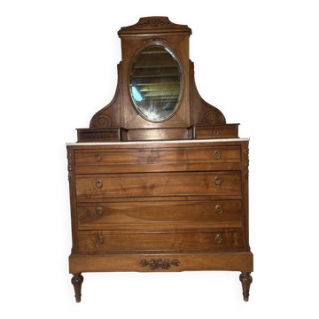 Antique carved wooden dressing table with marble and tilting oval mirror.