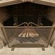 Fireplace screen in patinated gold iron