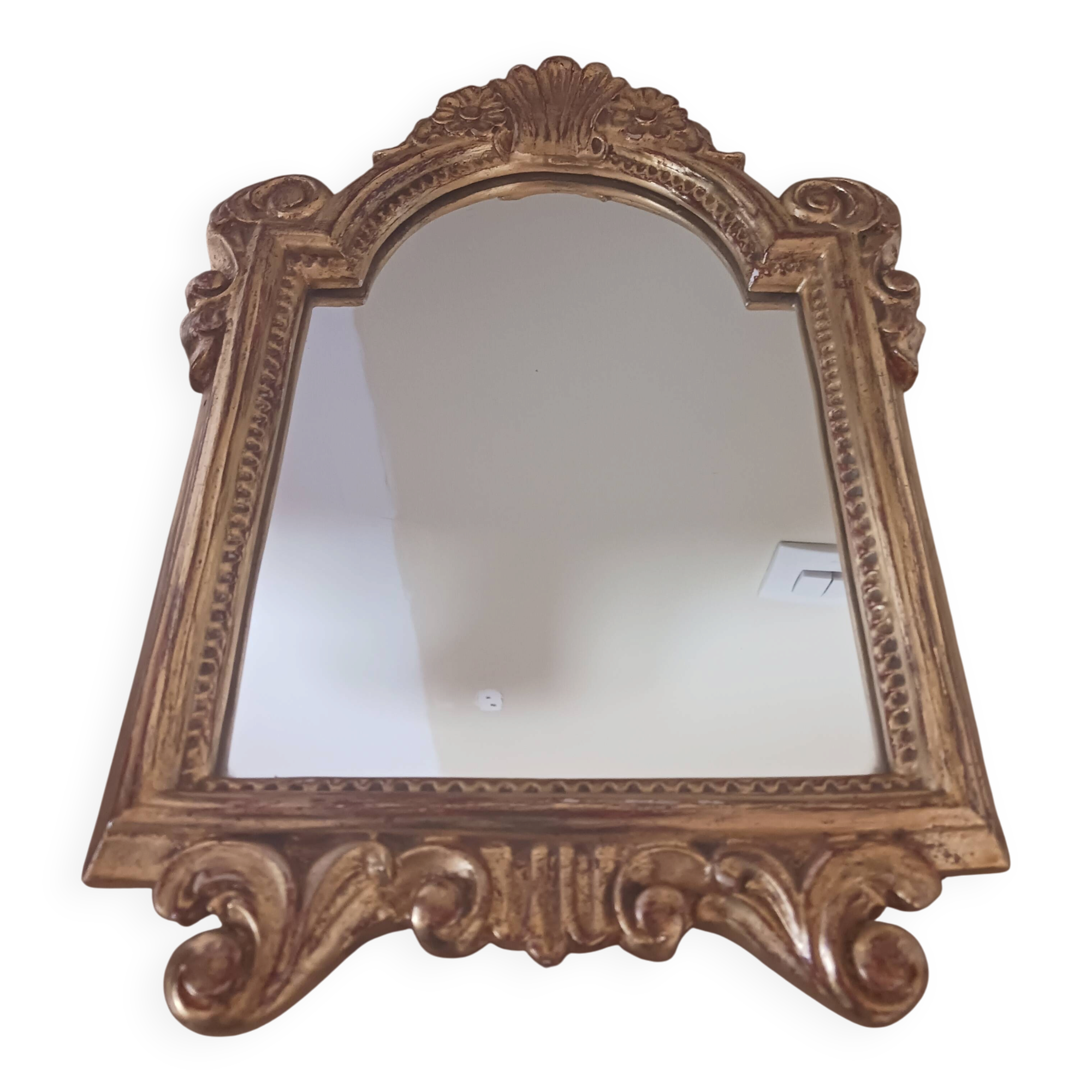 Antique mirror in gilded wood.