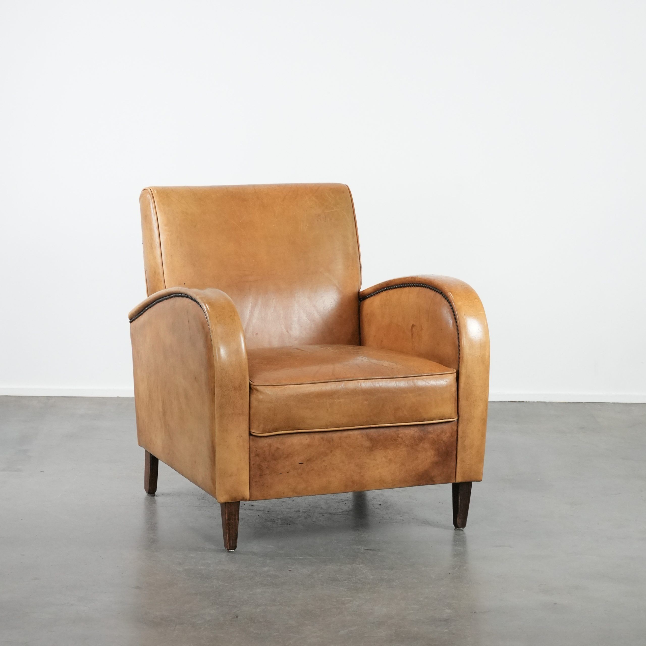Luxury armchair made of cowhide leather with a beautiful warm colour scheme