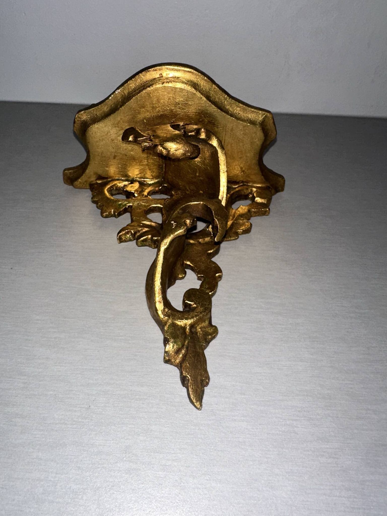 Antique wall-mounted console in gilded wood in rococo style.