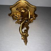 Antique wall-mounted console in gilded wood in rococo style.