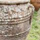 Large Cretan jar in terracotta with three handles on a stone base.