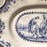 Oval plat in earthenware decorated with a hunting scene signed