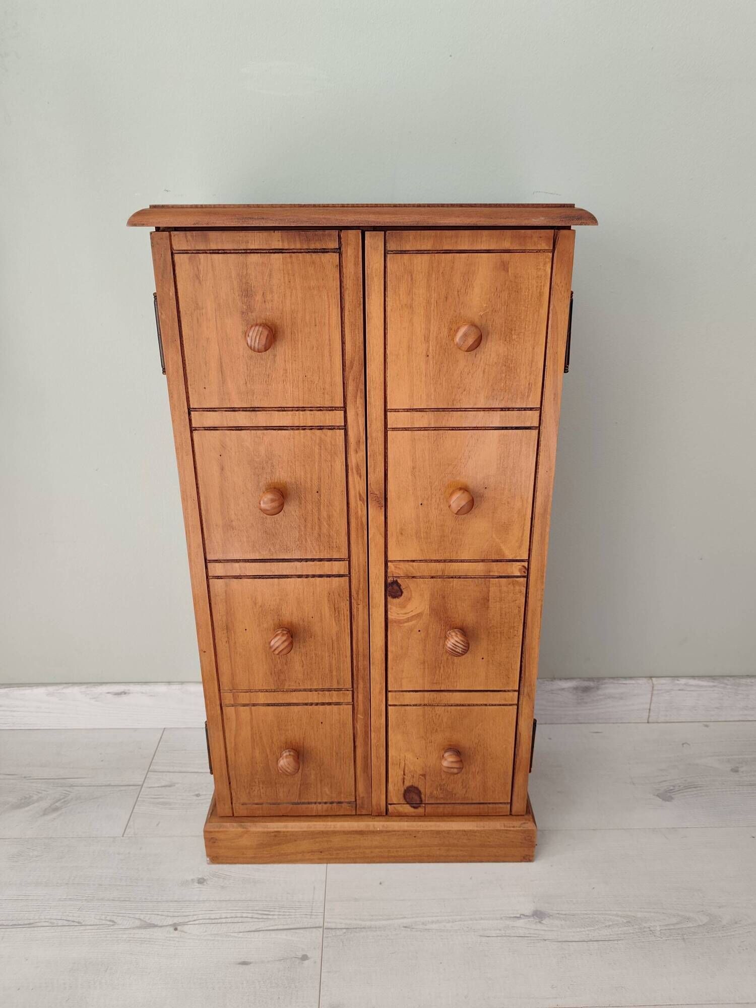 Small wooden piece of furniture, cabinet style, false drawers.