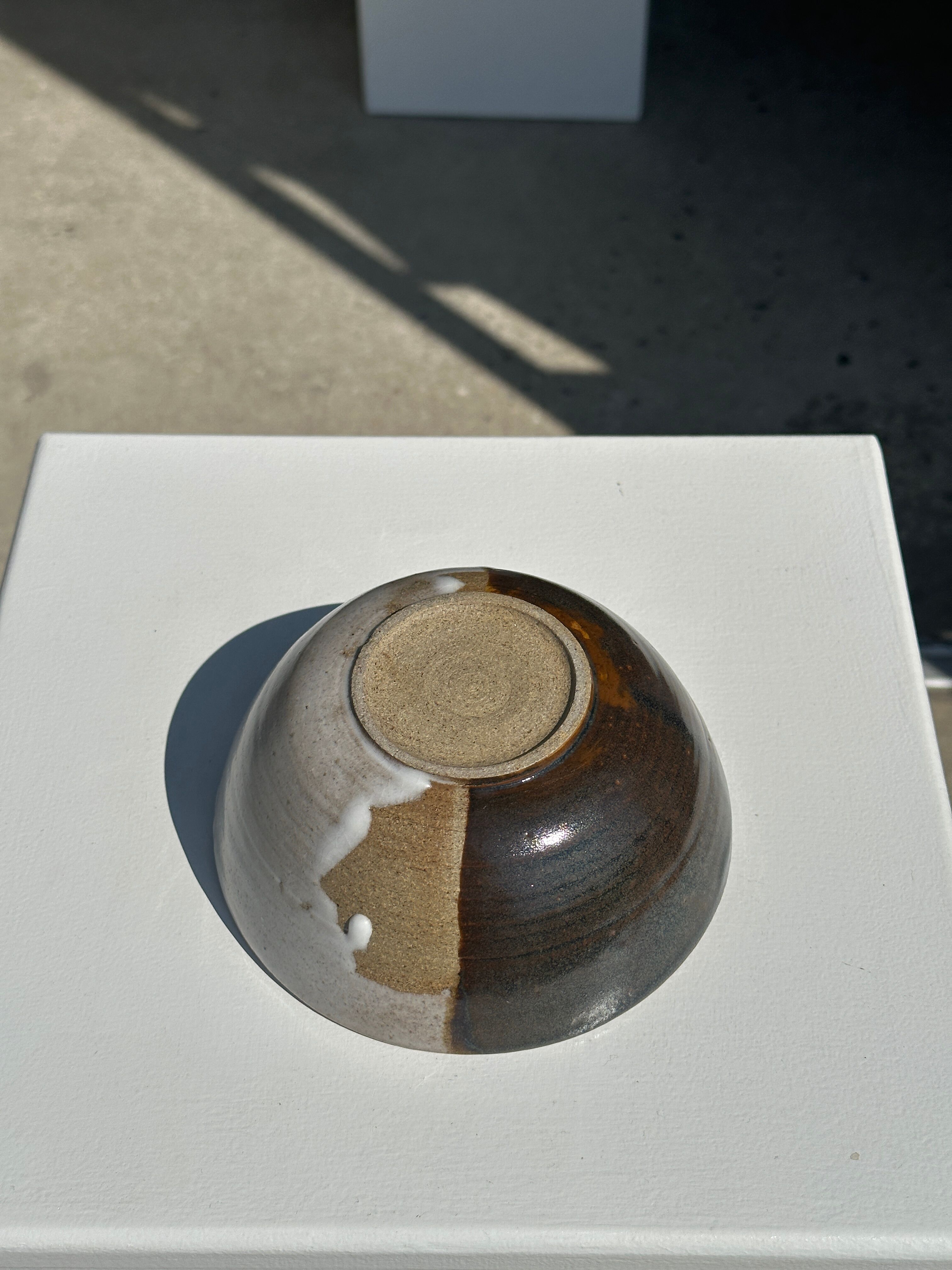 White and glossy brown two-tone ceramic bowl, matt earth