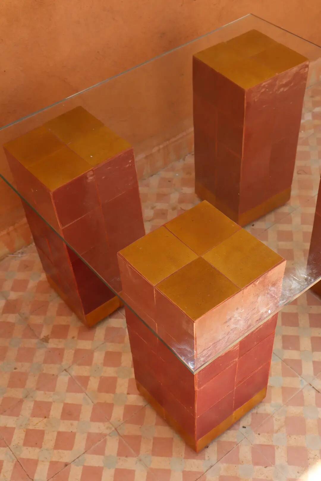 Modern coffee table in burgundy zellige with a tempered glass top.