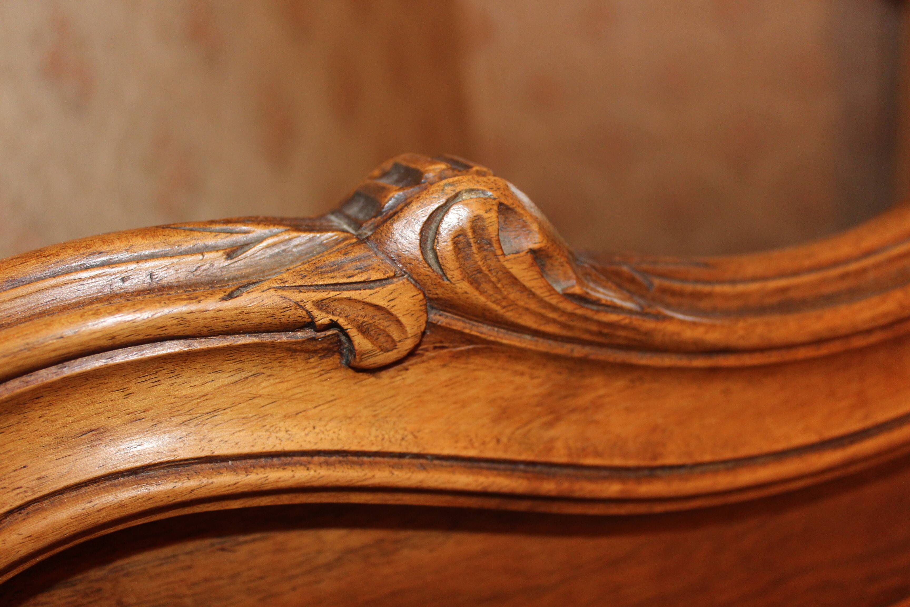 Walnut rocaille bed from the early 20th century.