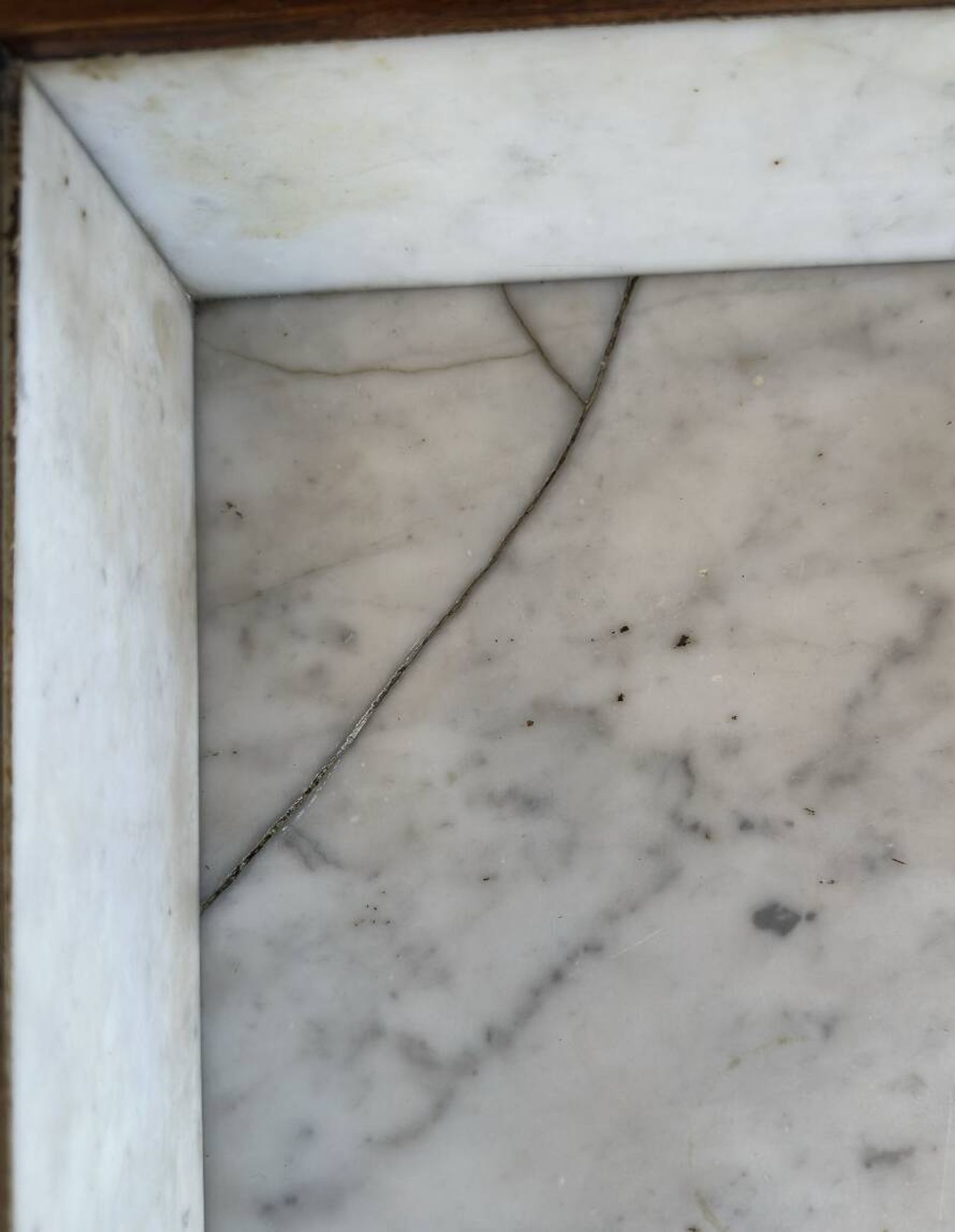 Antique bathroom cabinet with white marble and mirror.