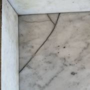 Antique bathroom cabinet with white marble and mirror.