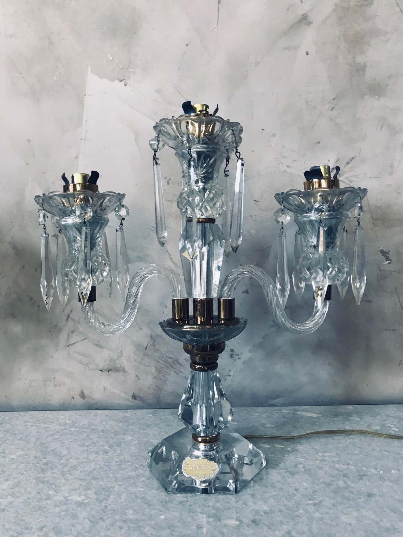 Pair of Sèvres candelabra in crystal and brass of the 20th century France 1950