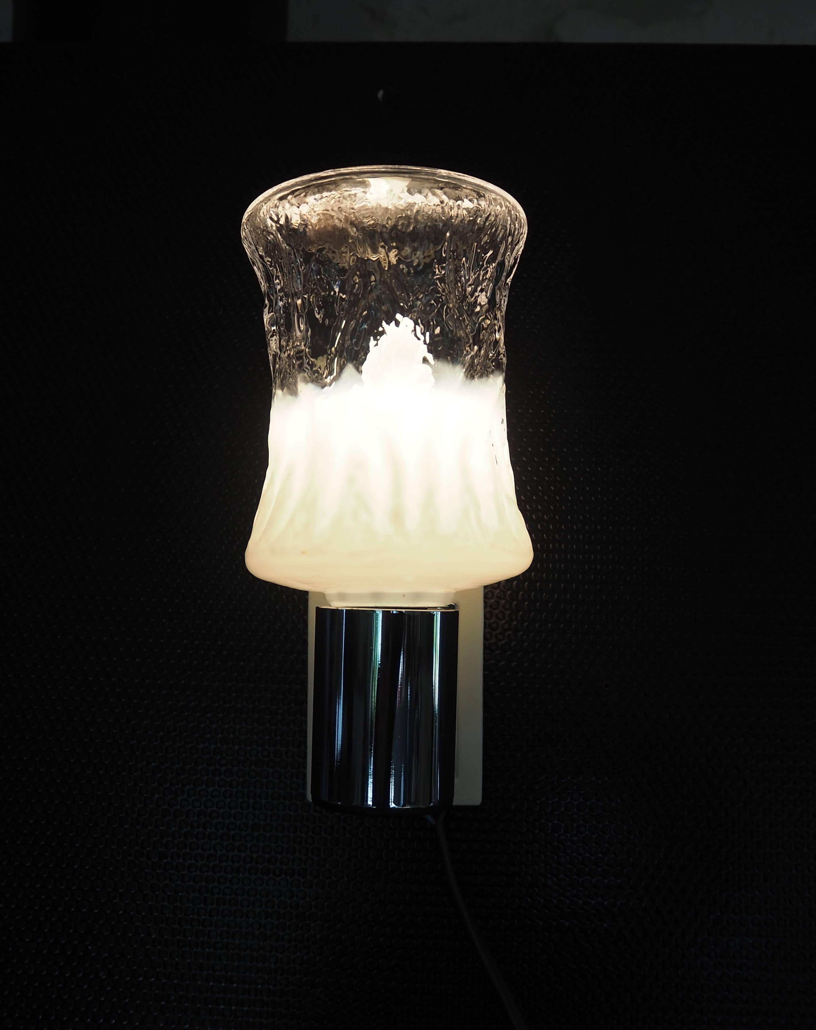 Torch type wall lamp in transparent and white glass