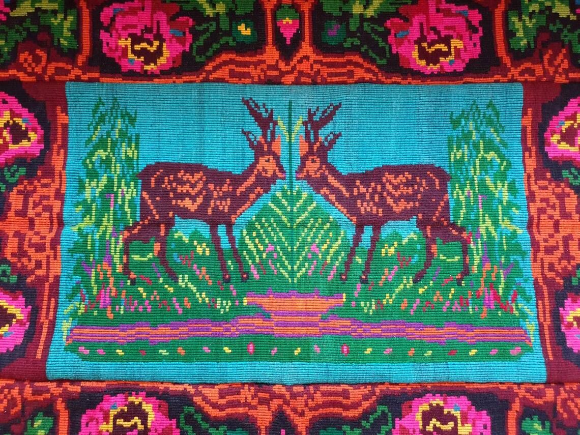 Vintage Romanian rug with deers, nature scenery on a floral background