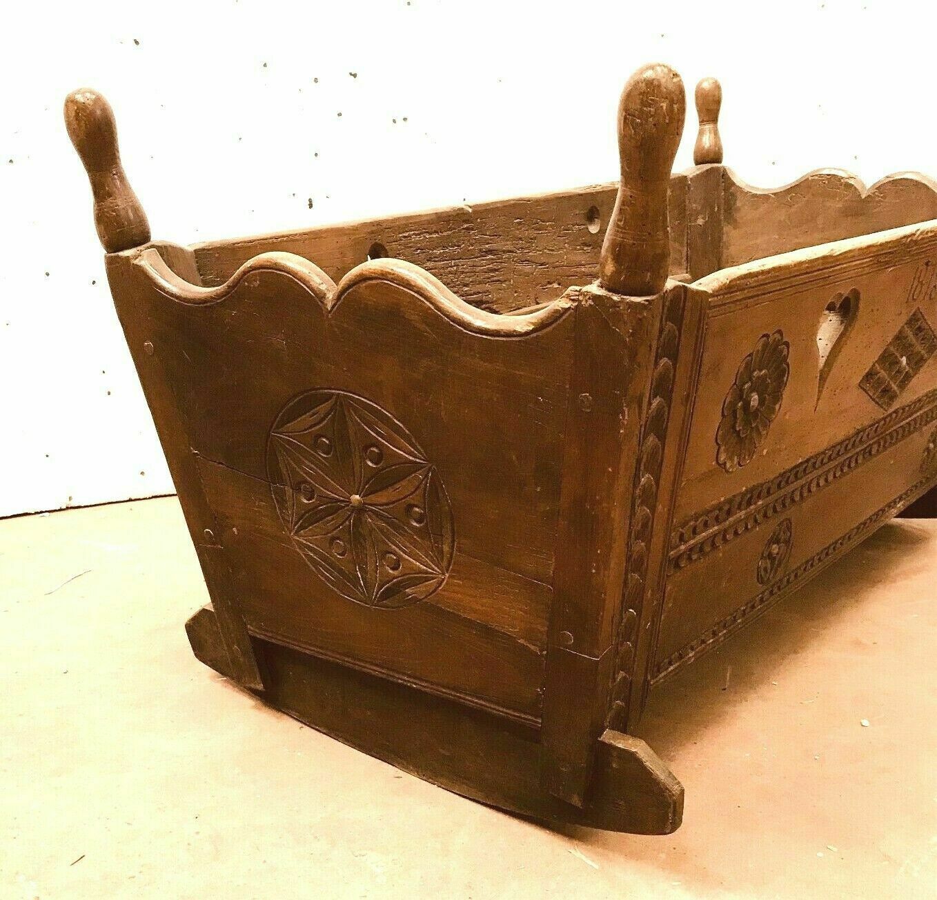 Sculpted walnut rocking cradle