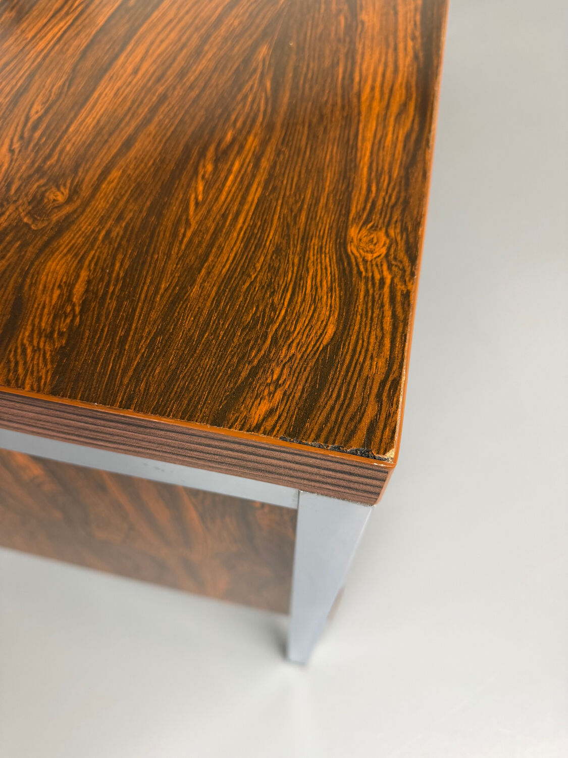Vintage desk with rosewood veneer and chrome metal design from the 1970s.