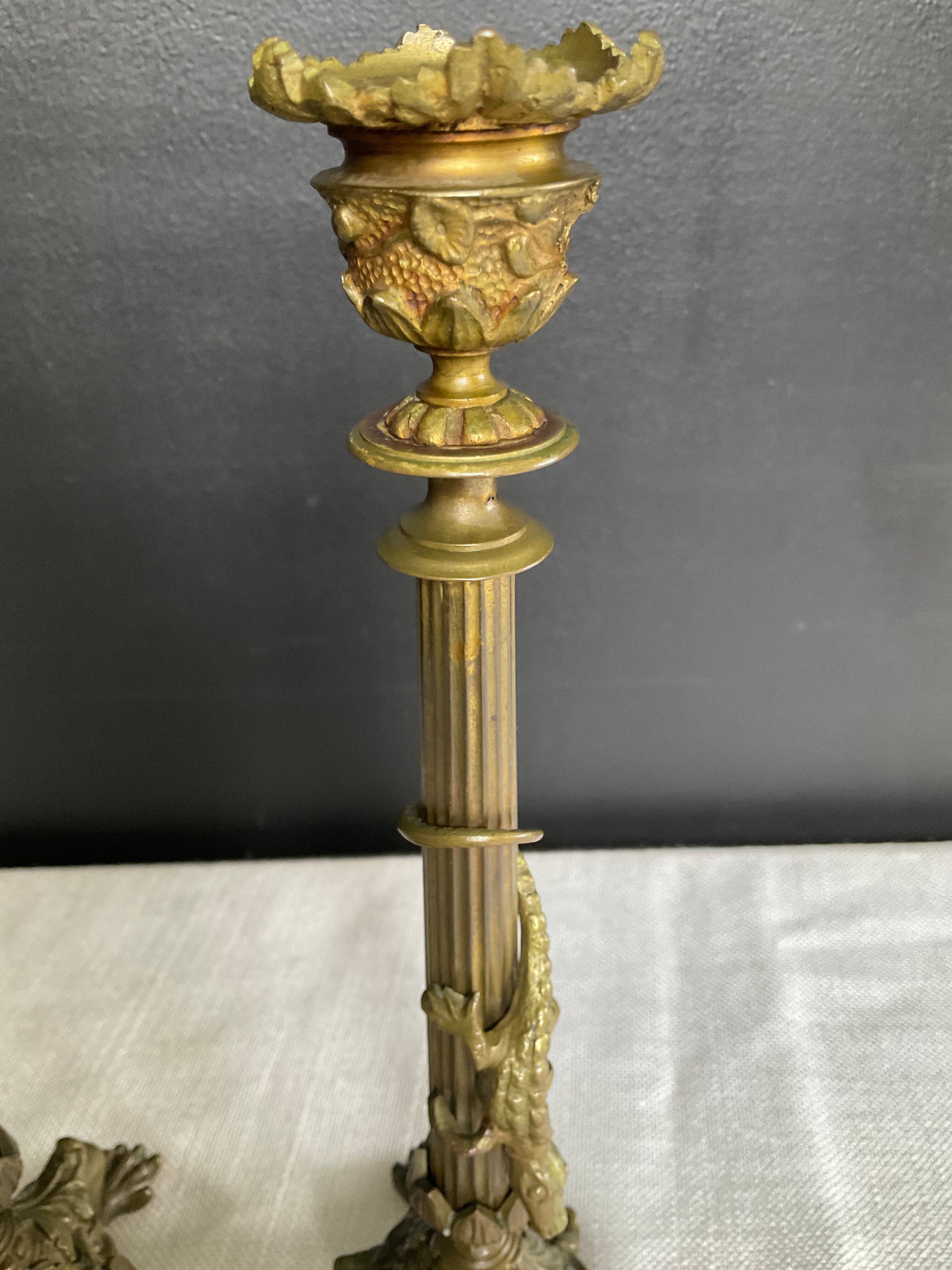 Pair of 19th-century gilded bronze candlesticks in Empire style.
