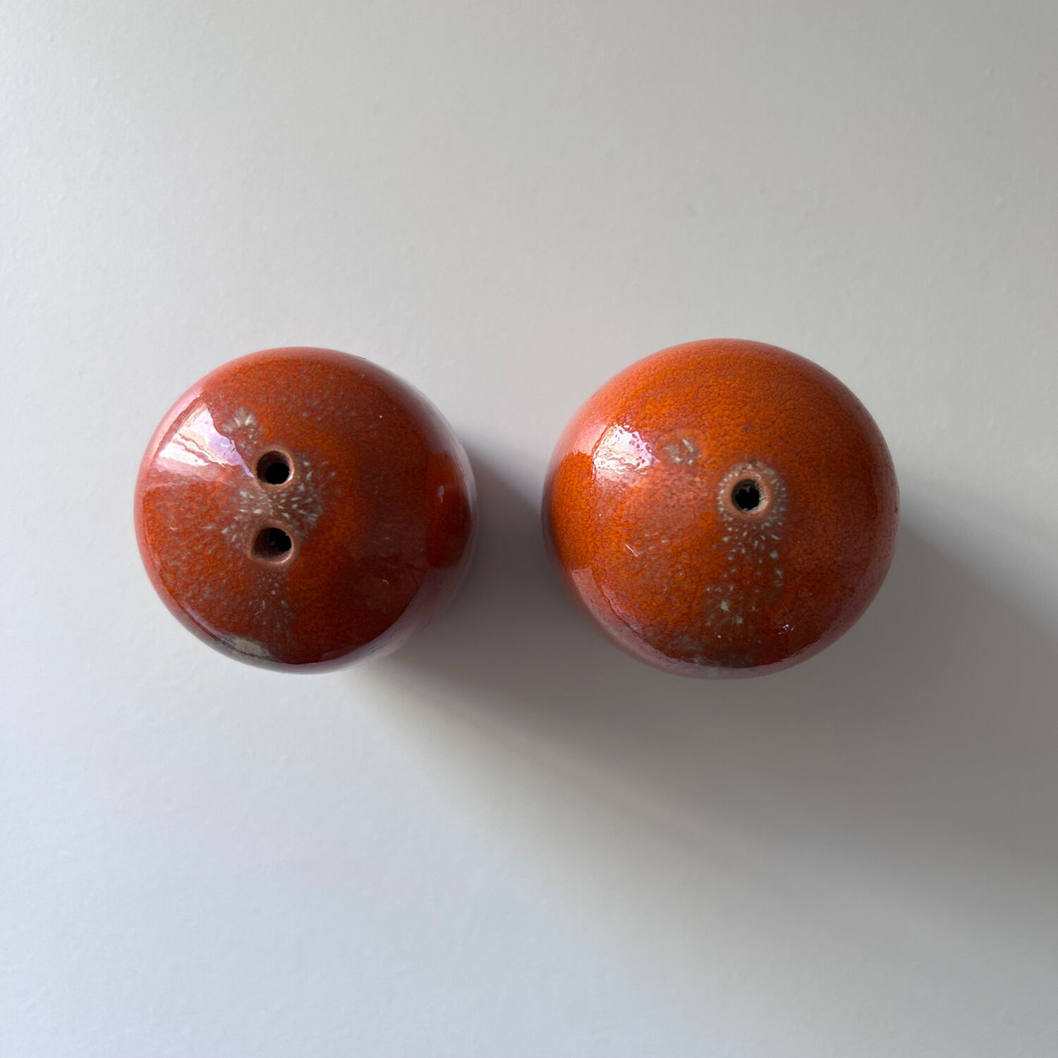 Salt and pepper shakers in orange stoneware