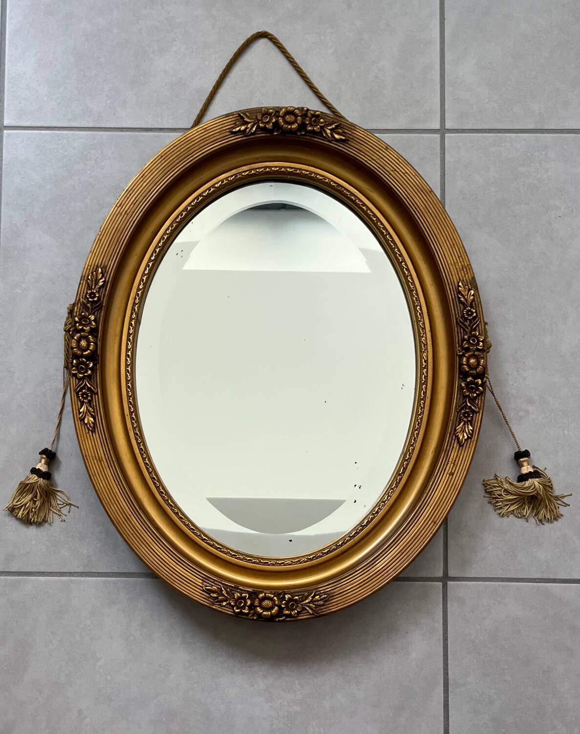 Oval gilt mirror and Art Deco trim