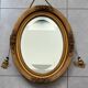 Oval gilt mirror and Art Deco trim