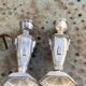 Pair of metal candlesticks, chiseled with a statuette in front, rose pattern in relief, art deco