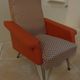 Vintage rockabilly retro armchair in orange faux leather and fabric.