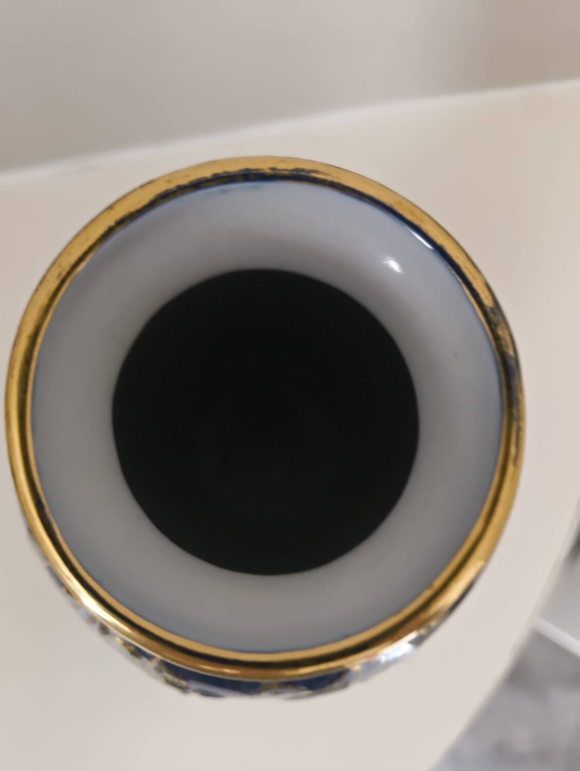Cobalt blue porcelain vase from Limoges, France with floral pattern.