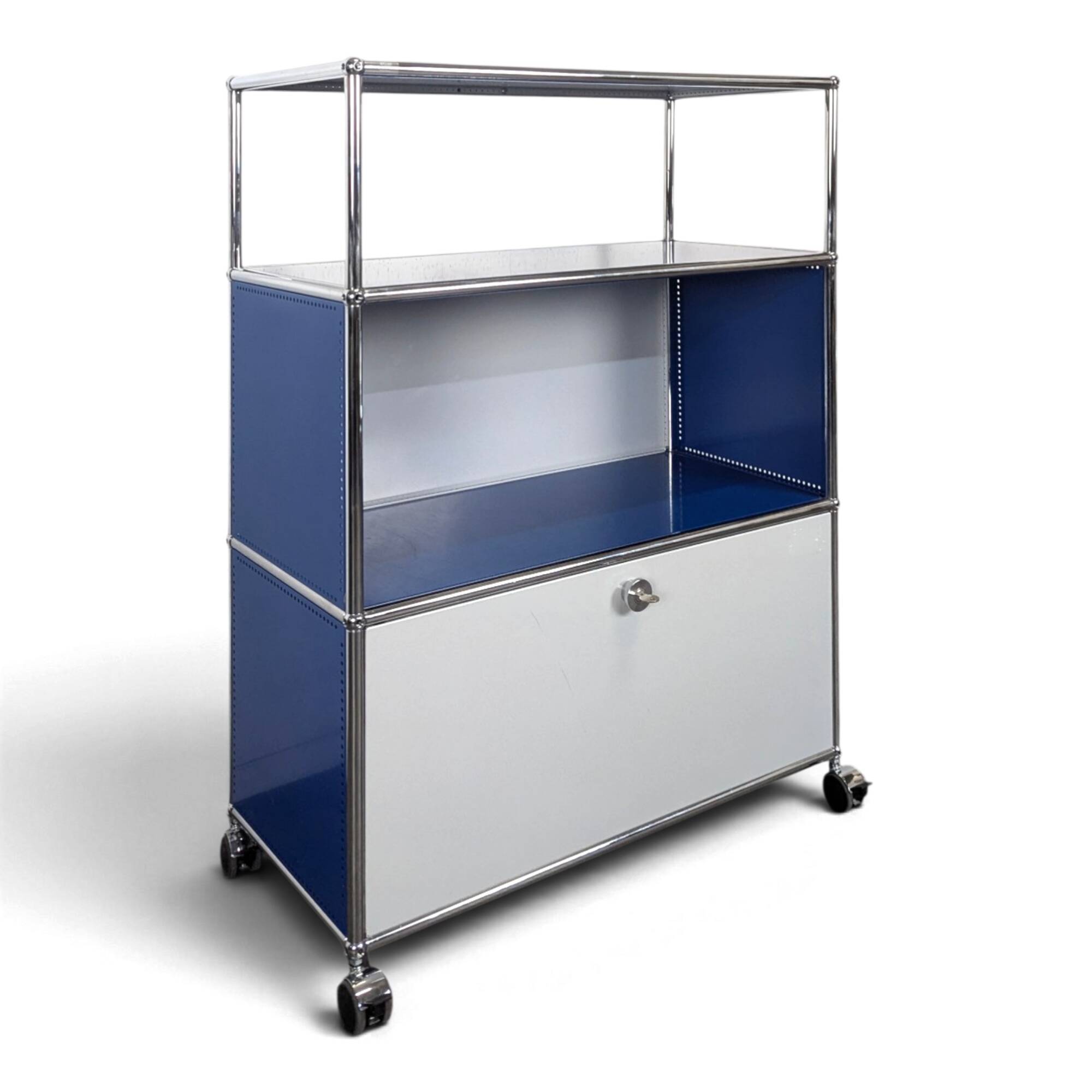 USM Haller furniture in gentian blue and white with a drop-down door on wheels.