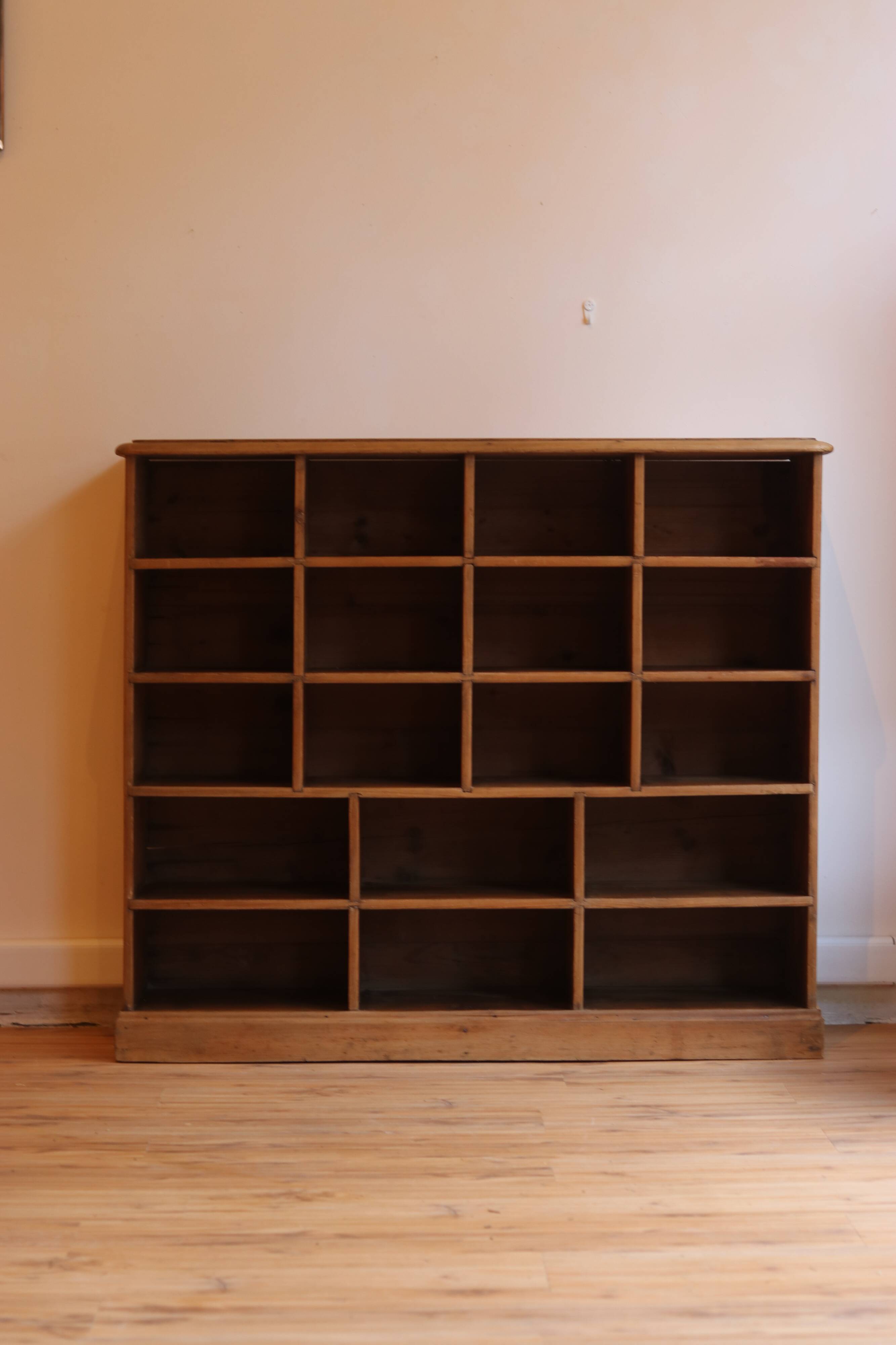 Large storage unit with compartments in waxed pine, early 20th century.